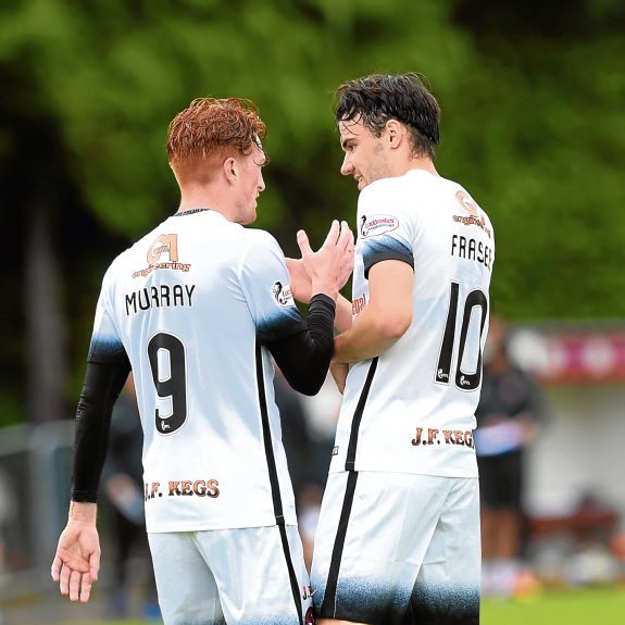 Scott Fraser is congratulated by United team-mate Simon Murray.