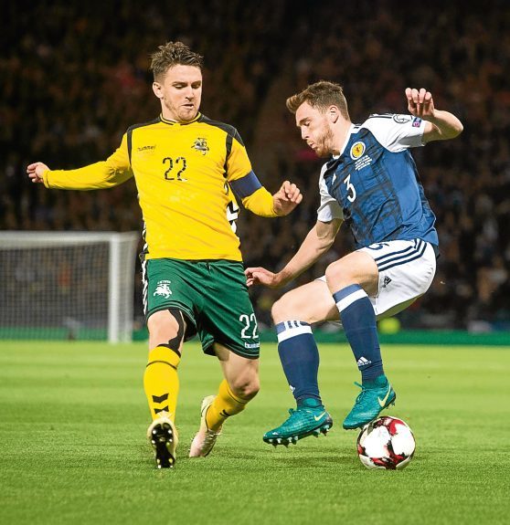 Andy Robertson competes with Lithuania’s Fiodor Cernych at Hampden.