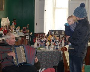 Accordionist Alec MacKinnon plays for Angus Fee, 10 months and his dad Daniel Fee.