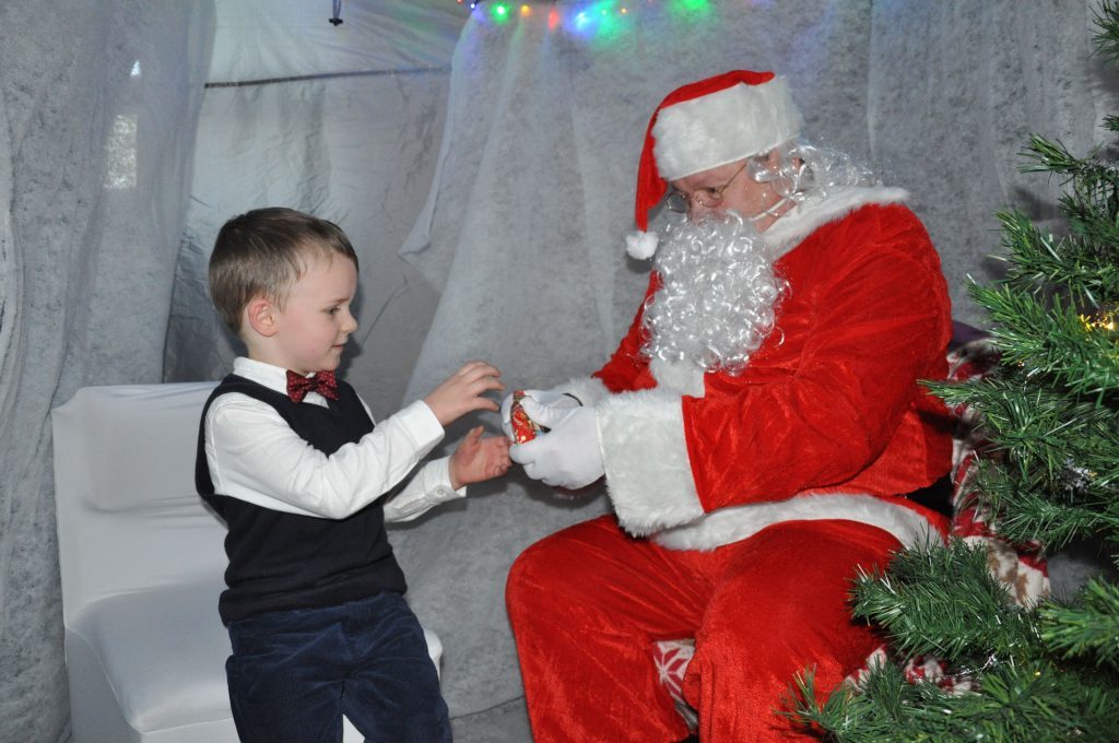 Peter Mochan receives a present from Santa at the Corrie community Christmas party