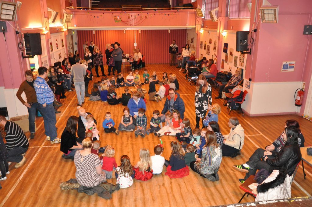 Brodick children form two circles while playing pass the parcel