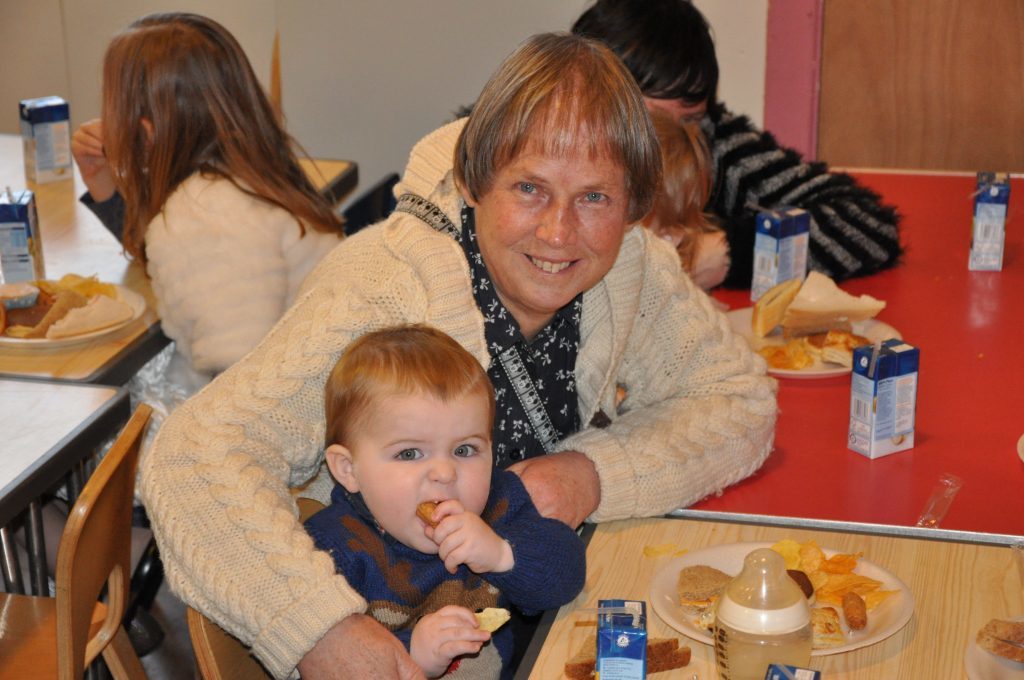 Young Noah MacLean enjoys his festive snacks and treats in Brodick with his grandmother