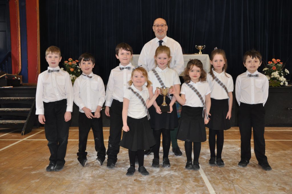 Shiskine Primary and adjudicator Eric Findlay with the Corrie Scottish Country Dancing Cup