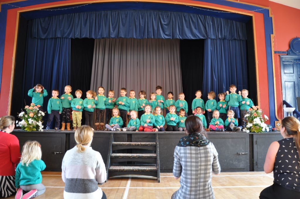Teachers lead the Lamlash Early Years pupils who performed True Colours - complete with hand actions