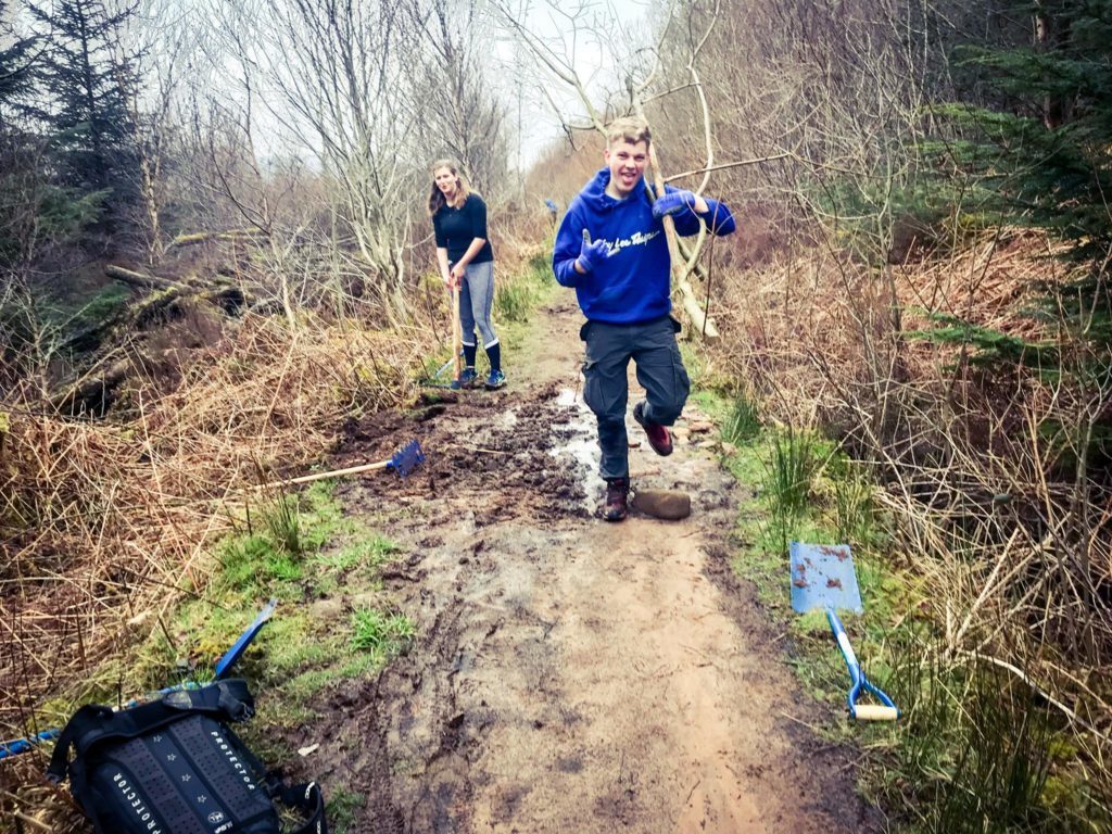 Mountain bike club members set to work on a waterlogged section of the trail.