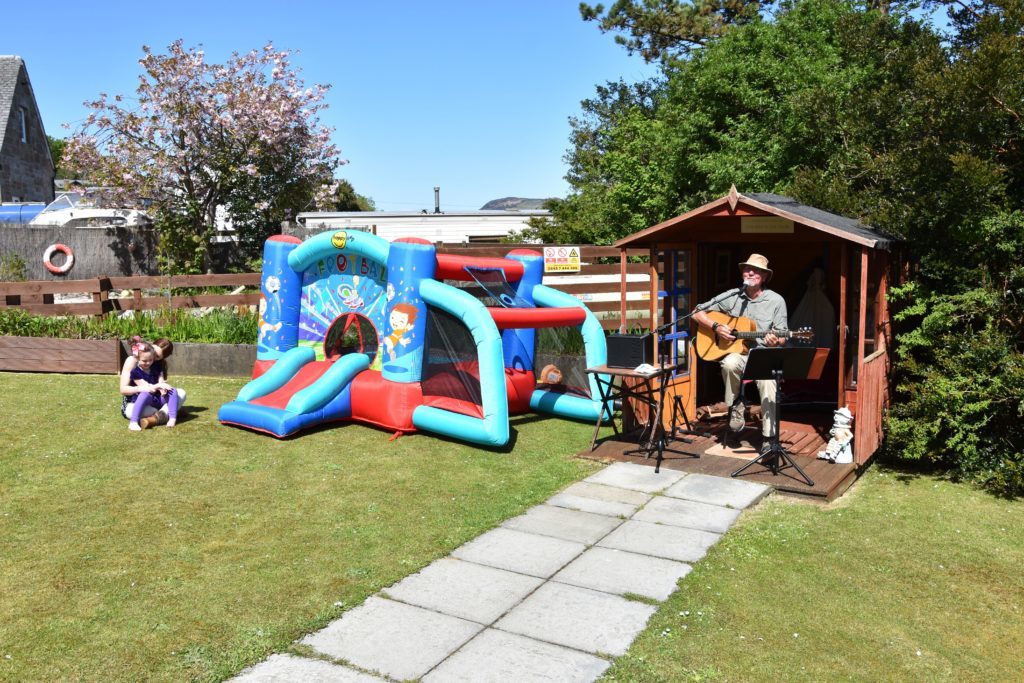 Singer Mike Bailey entertained the crowds while children put the bouncy castle to good use.