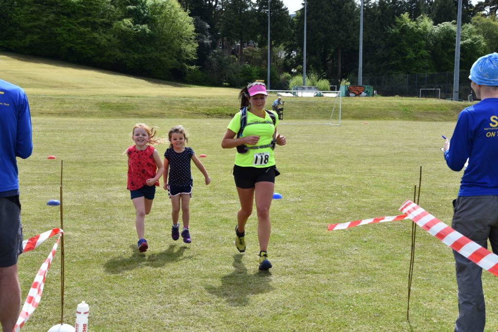 Arran Fell Runner, Michelle Williamson is joined by her two daughters over the finish line.