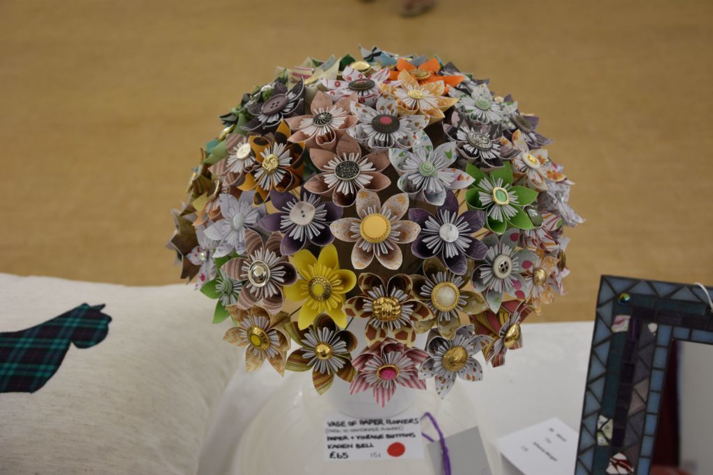 Painstakingly detailed, a vase of over 70 individually crafted flowers drew admiration from visitors.