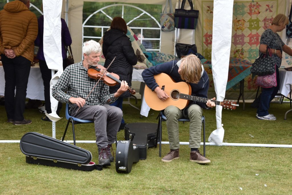 Providing the musical backing, Alastair and Mungo Paul entertain the visitors.