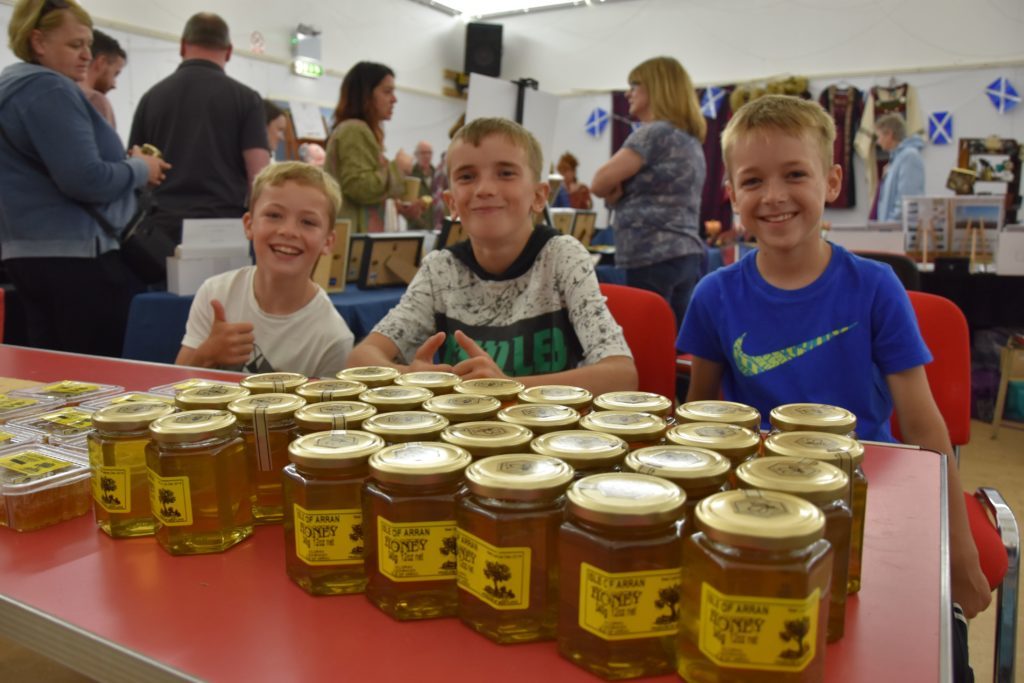 Sweet smiling faces, Fergus West, Ewan Morrison and Scott O Neill host a honey stall in the village hall.