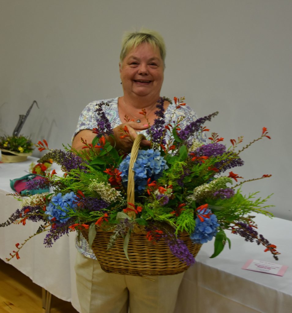 With a natural flair with flowers, May Crawford exhibited her best in class wicker basket of cut flowers.