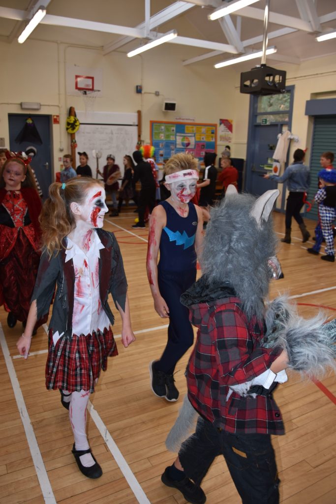 The monsters parade, children walk around the hall during the costume judging.
