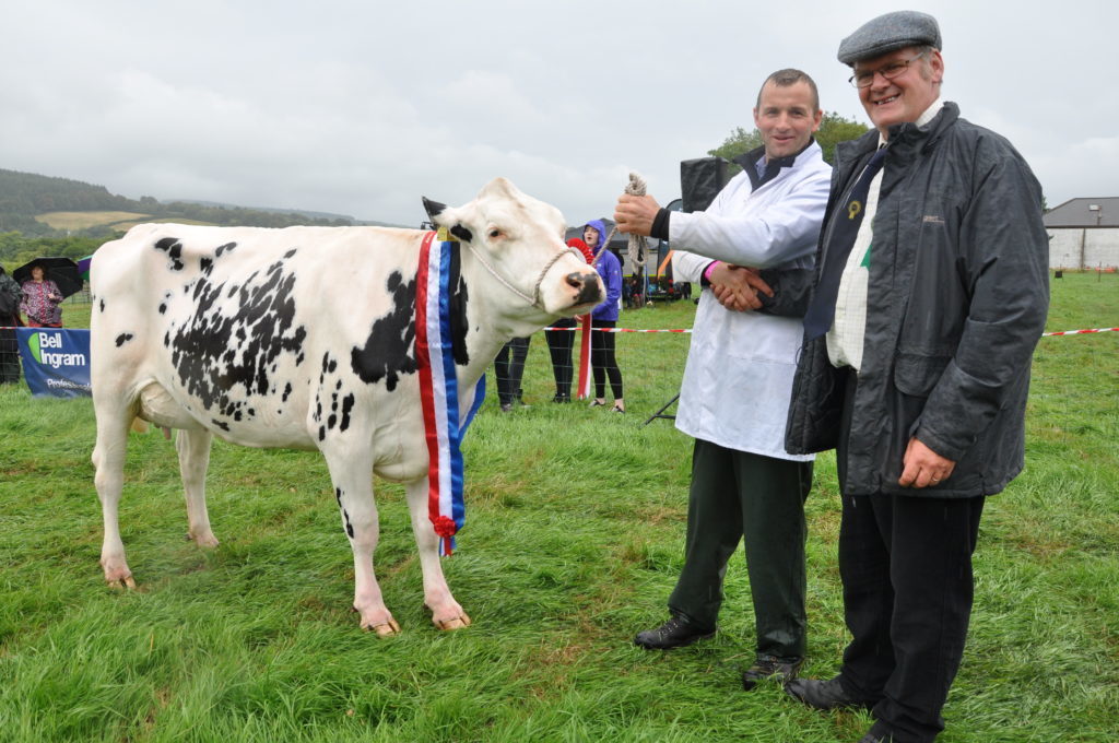 AUGUST - Chairman Richard McMaster congratulates Stuart Reid on winning the overhead championship at the Arran Farmers' Society Show.