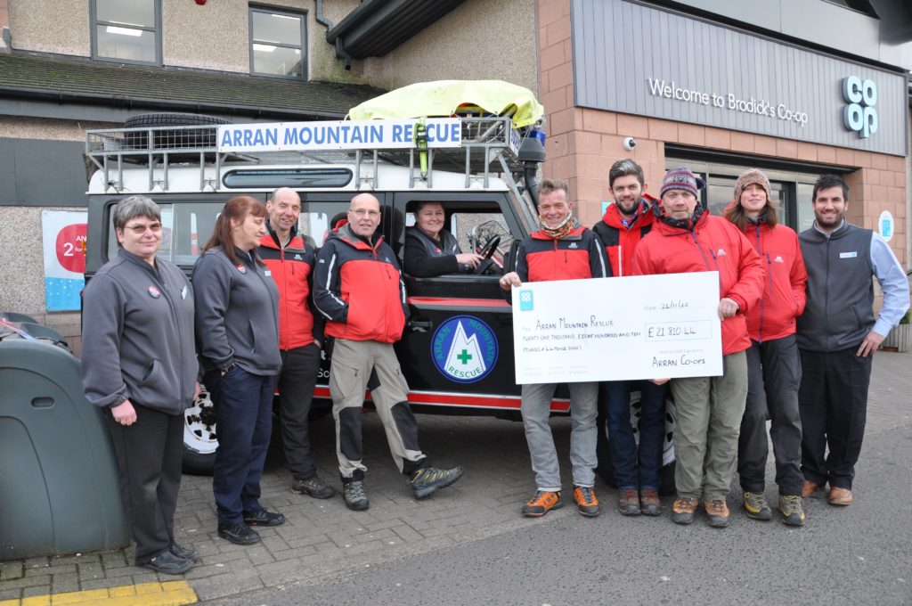 DECEMBER - The Arran Mountain Rescue Team and Feis Arainn were the two community groups on Arran who shared a £40,000 donation from the Brodick Co-ops community fund. Here store manager Liz McLean presents rescue team volunteers with a cheque.