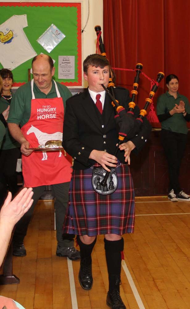 Piper Rory Currie pipes in the haggis.