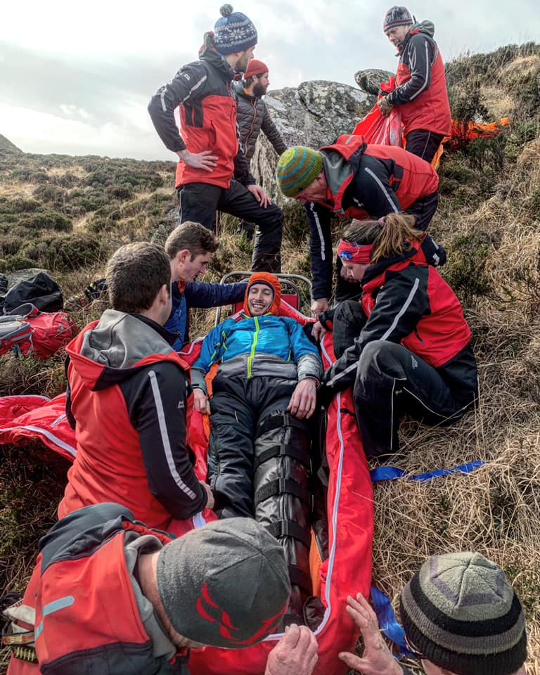 A 'casualty' is packaged into a stretcher for evacuation.