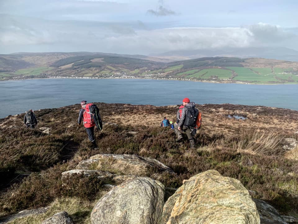 Rescuers are pictured high on the hills of Holy Isle evacuating a casualty.