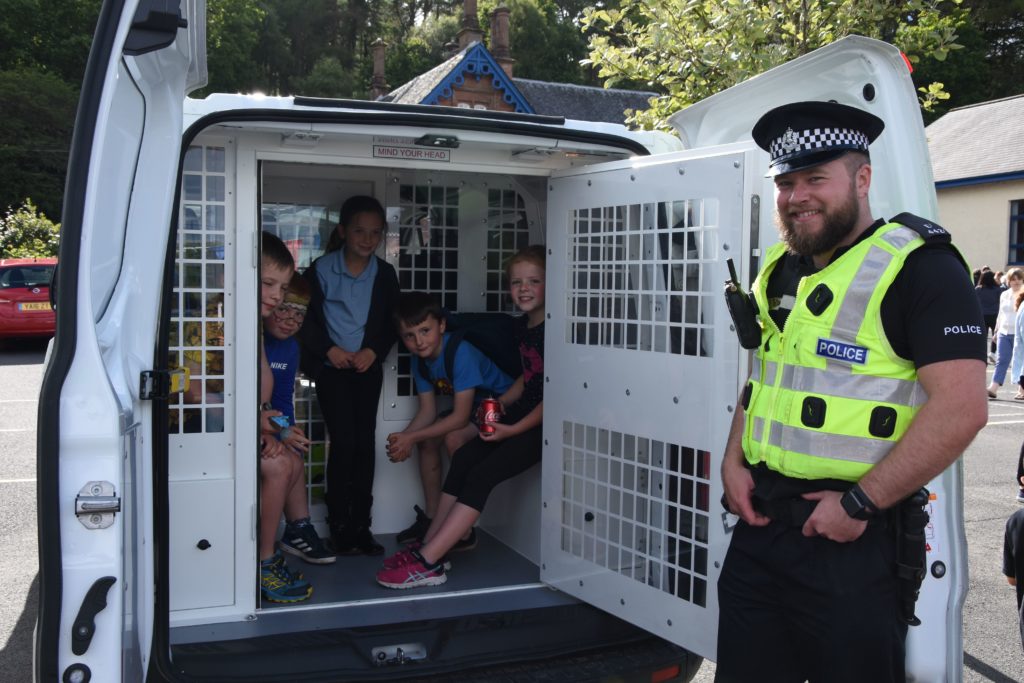 The friendly face of the police, PC Sam Davidson spoke to the children about crime and allowed them to climb inside the police vehicle.