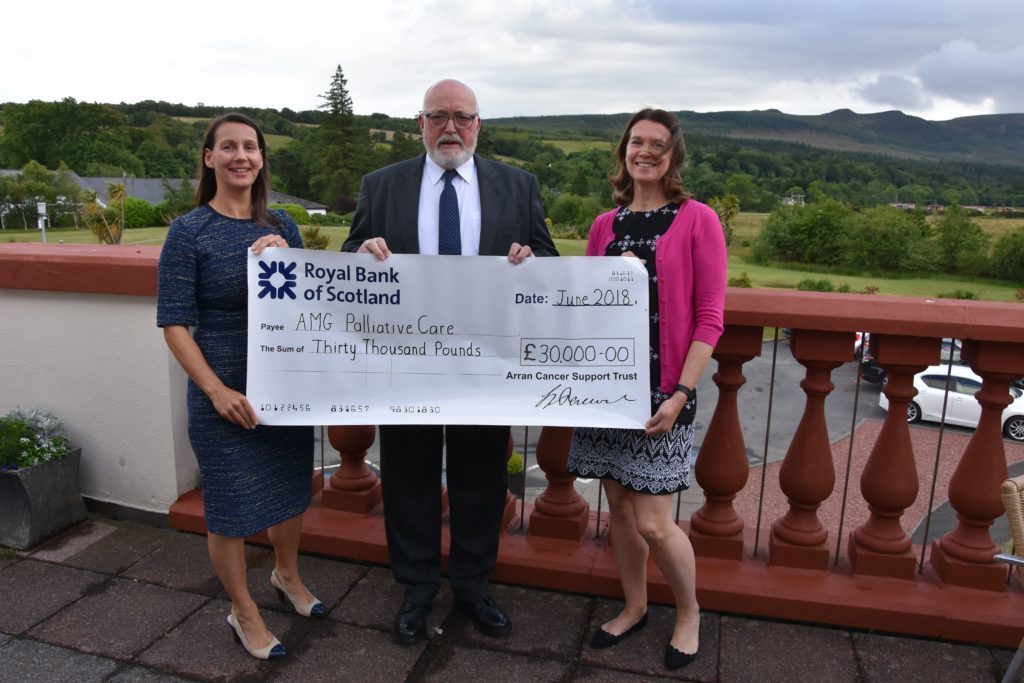 Douglas Johnston hands over a cheque for £30,00o to the Arran Medical Group for palliative care last year.
