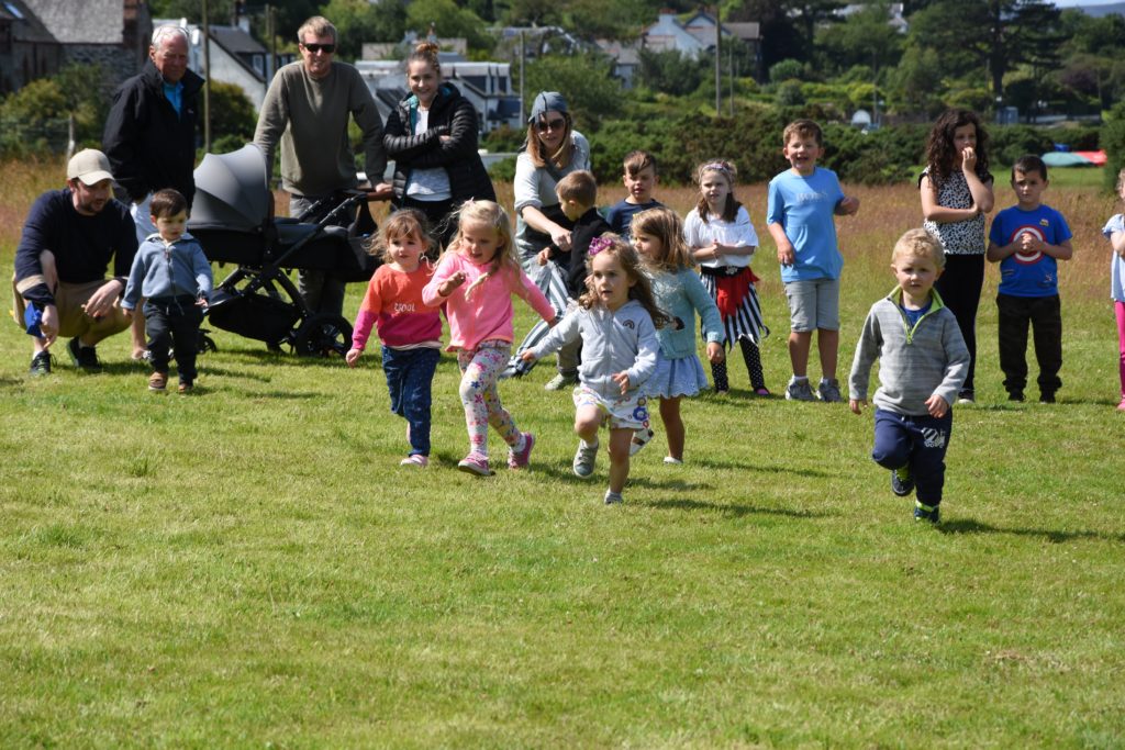 Youngsters take part in the three year old race category with parents and supporters cheering from the sidelines.