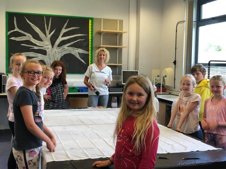 Art teacher Cil Paul and pupils prepare to start work on the Fèis banner.