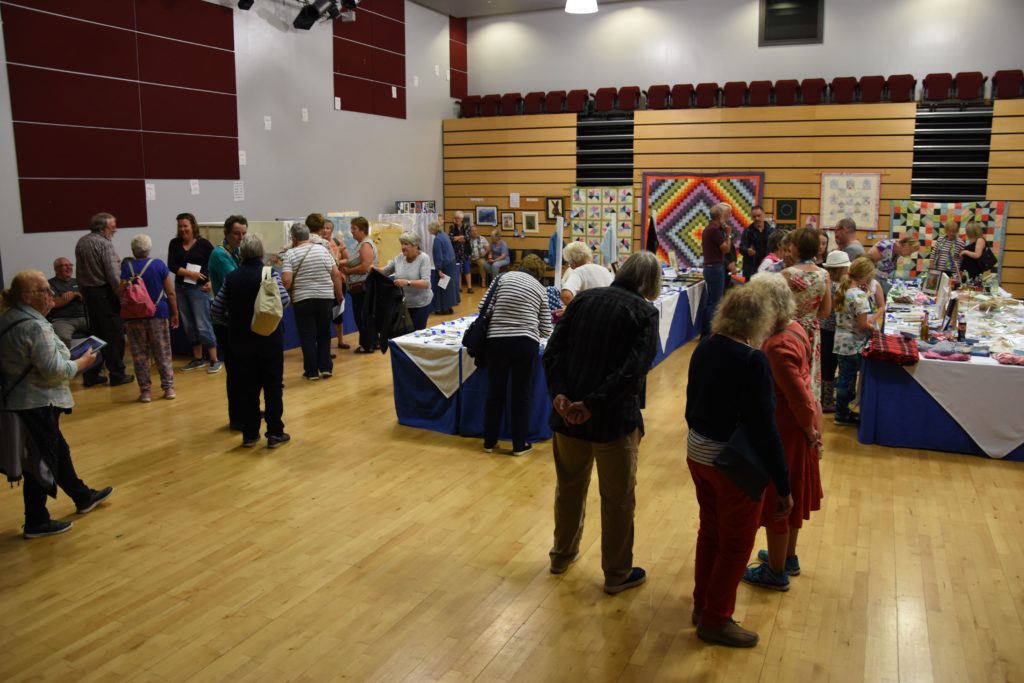 Visitors browse the huge assortment of exhibits on display in the theatre which have been laid out in a new format this year.