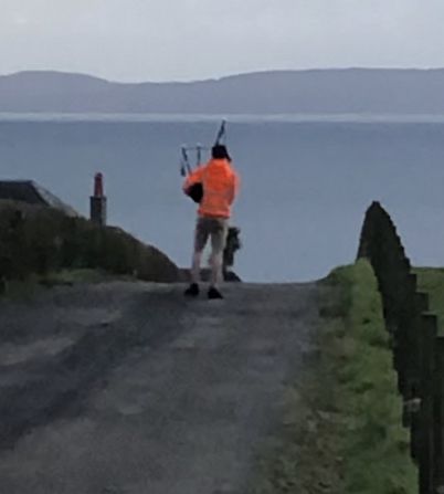 Donald Currie overlooking the Kilbranan Sound plays his pipes in Blackwaterfoot.