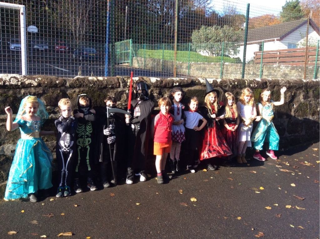 An assortment of ghosts and ghouls are flanked by two princesses at Whiting Bay primary.