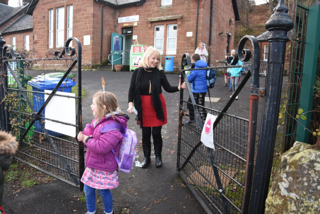 Mrs Todd sees the children out of the school gates for the last time.