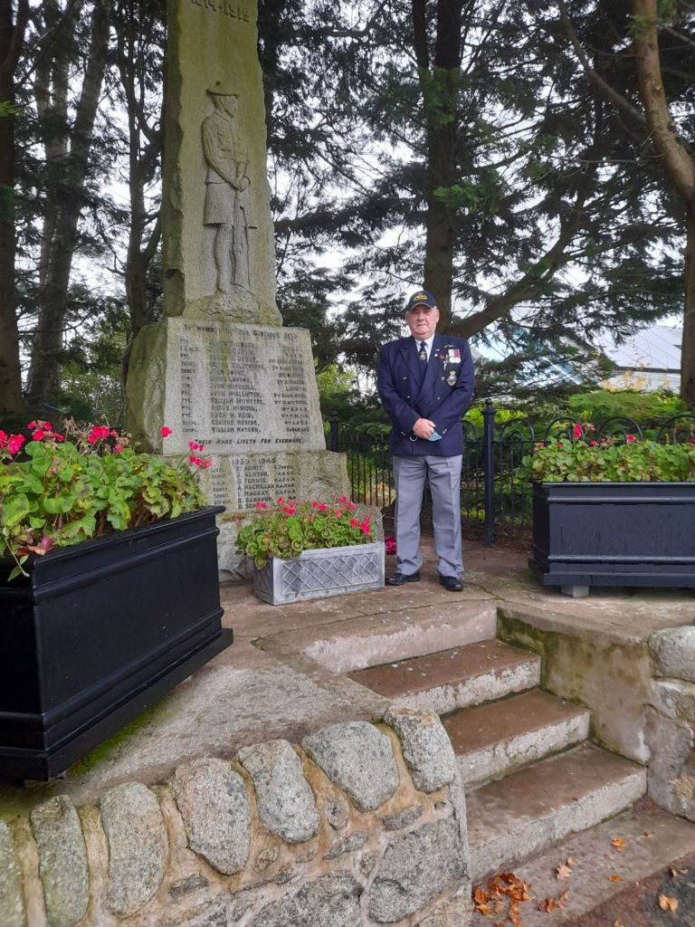 NOVEMBER: With no organised events permitted for Armistice Day, individuals attended cenotaphs privately to pay their respects to the fallen. Former submariner Alan Milligan placed a wreath of poppies on behalf of the Brodick community at the War Memorial in Brodick. Photograph: Norma Davidson. NO_B46remember02