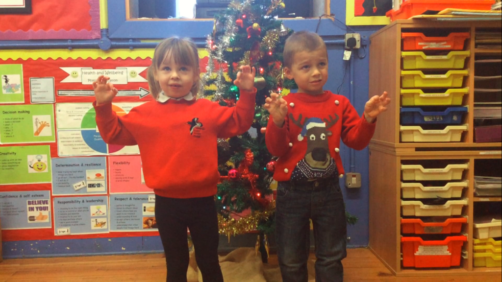 Two pupils at Pirnmill primary show their Makaton sign language.