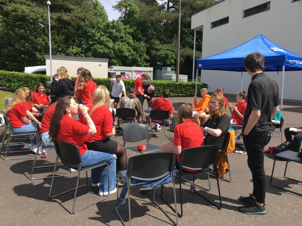 Pupils enjoy a barbecue in the afternoon sunshine.