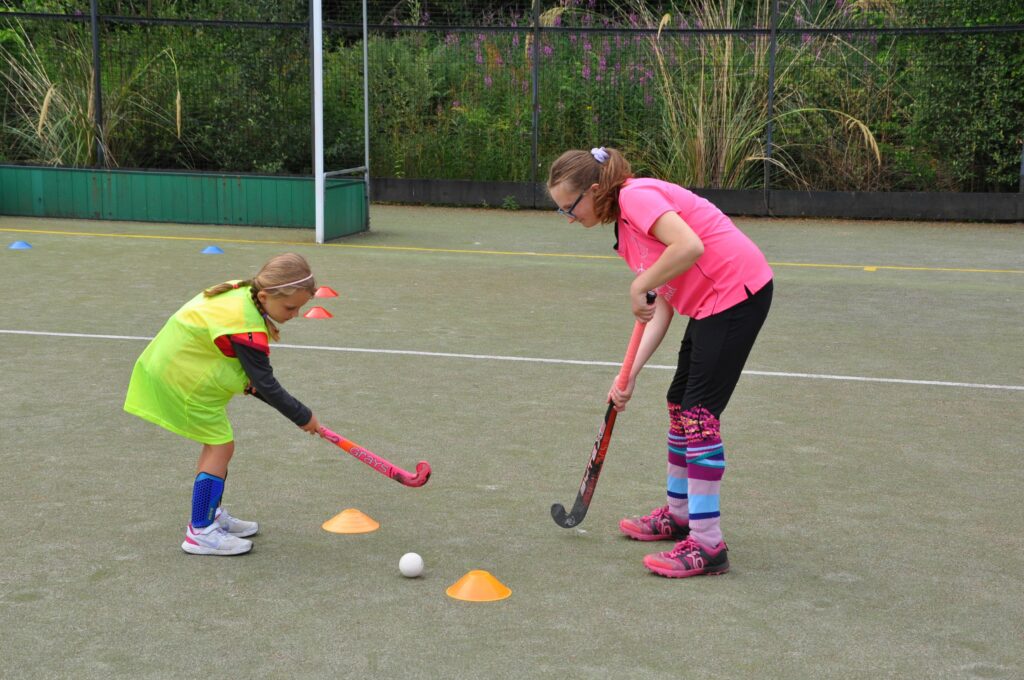 Mia Walkers gives a young hockey player some one-on-one ball control training.
