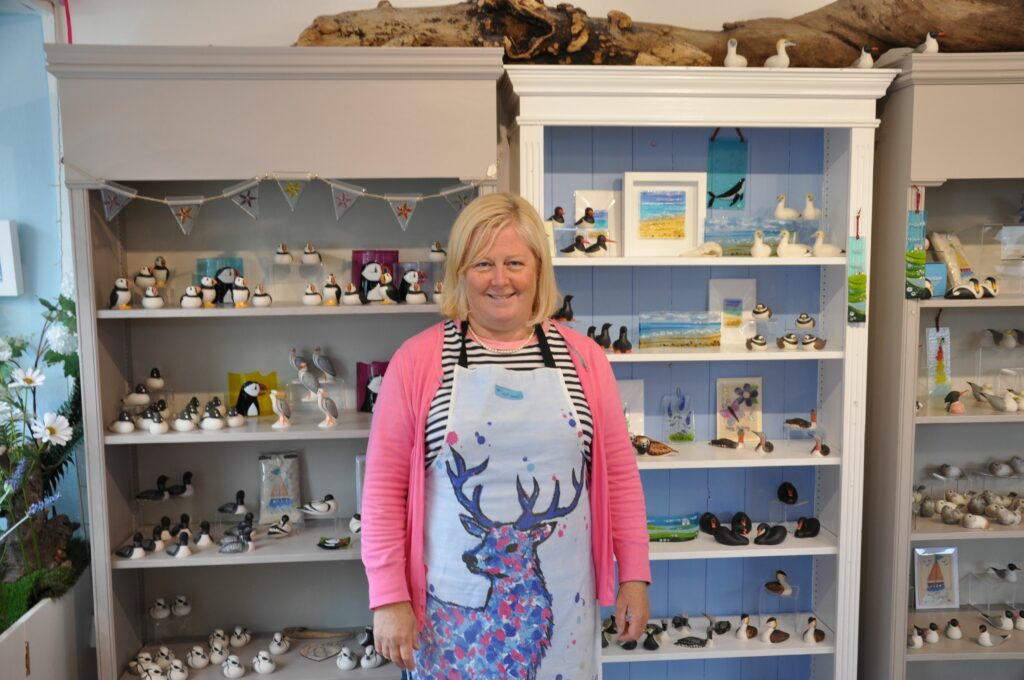 Tracy Gibson of Island Porcelain with some of her creations on display behind her.