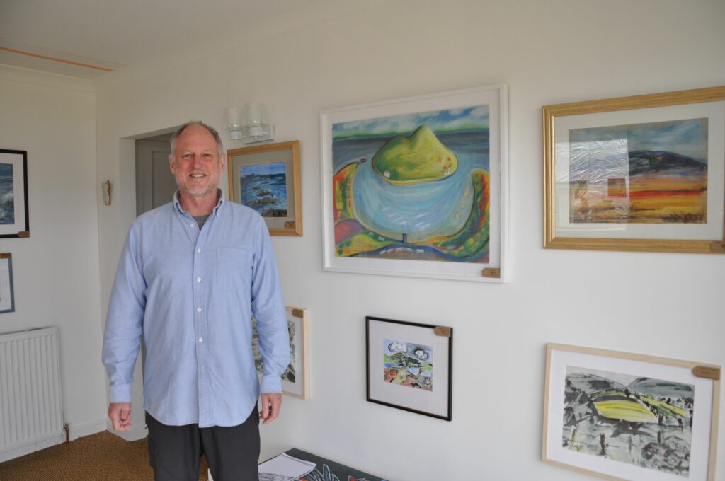 Andrew Binnie with some of his mixed media images which are inspired by Arran’s waters and mountains.