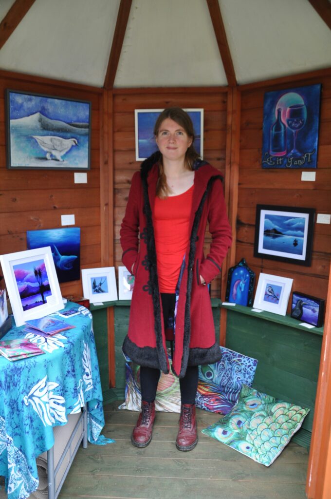Catherine Rose Scott of Catherine Rose Muralworks with some of her bright artwork created with acrylics on canvas.