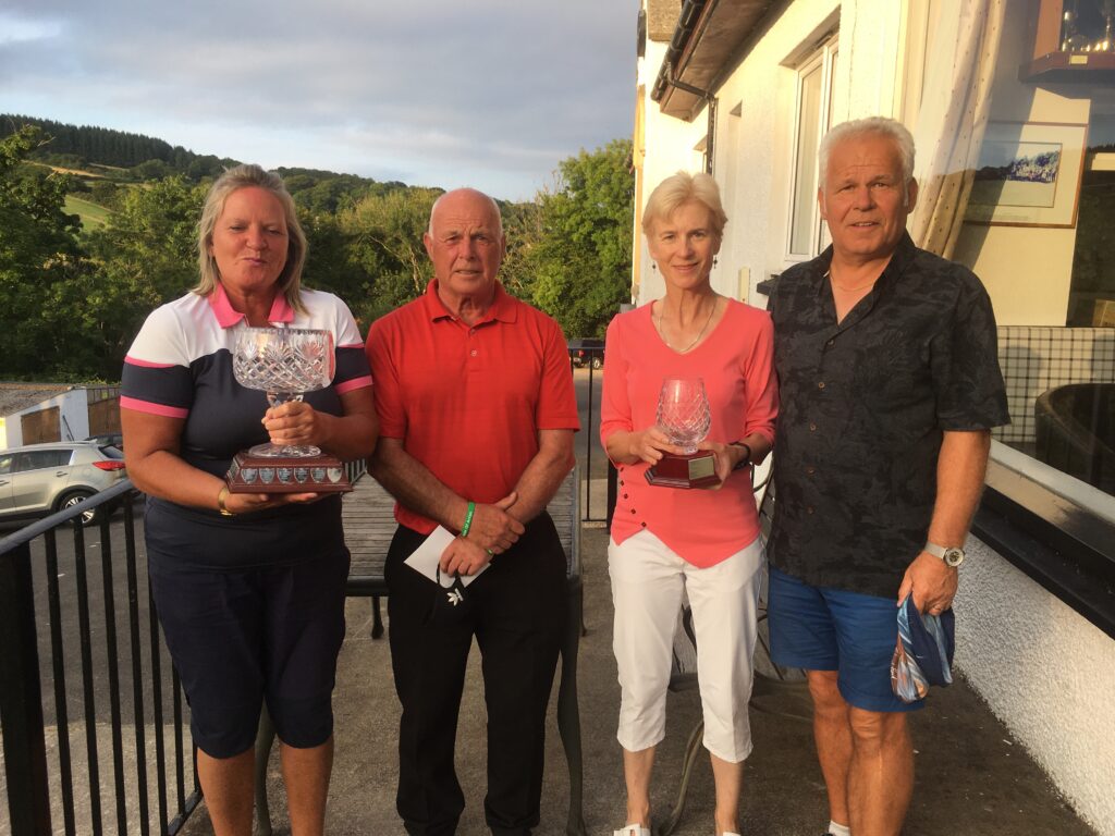 Overall winner and scratch winners, Gay McKay and Derek Harrison and Alastair and Valerie Crawford, with their trophies at the Island Mixed Fours at Lamlash Golf Club.