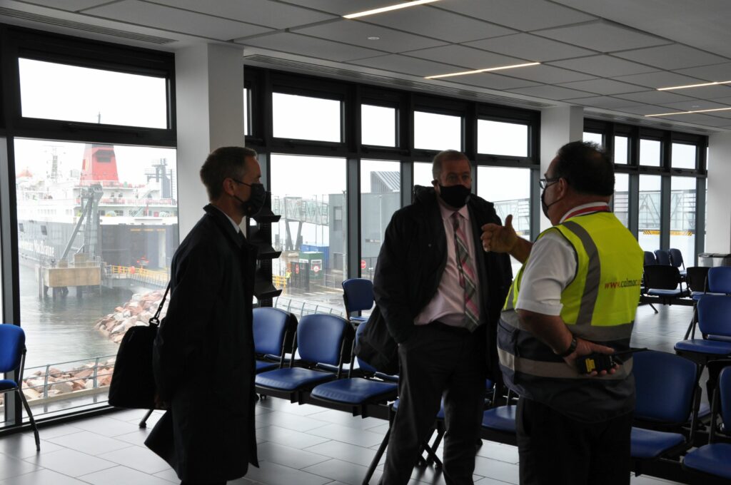 Mr McCort speaking to Mr Dey and Mr Drummond in the departure lounge.