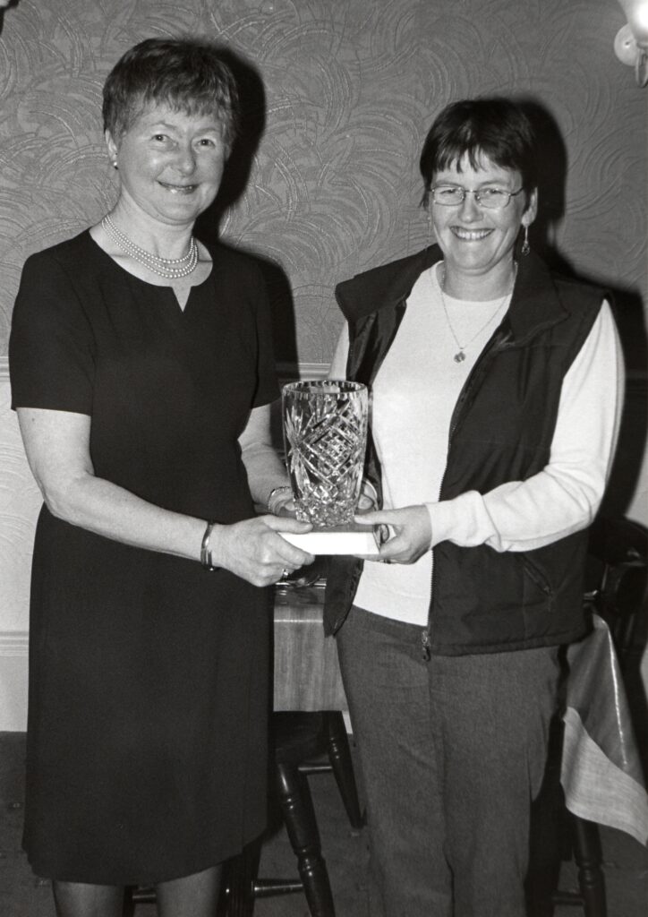 Alison Dick, retiring captain, is presented with the Lady Championship Crystal by new lady captain Margaret Auld at Whiting Bay Golf Club.