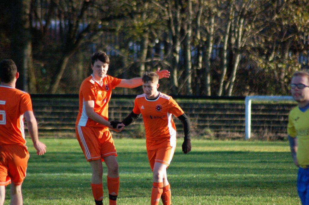 Kieran Rae is congratulated by his teammate after scoring.