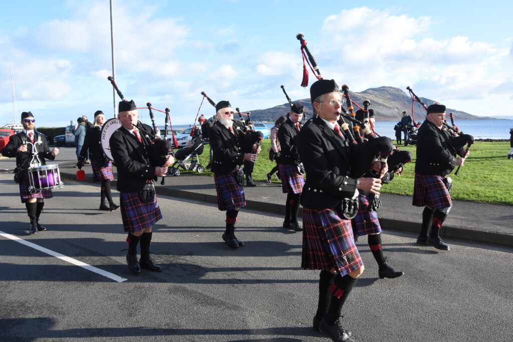 The pipe band with Holy Isle in the background.