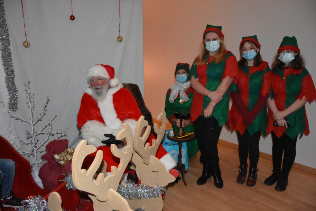 Santa in his grotto with his elves.