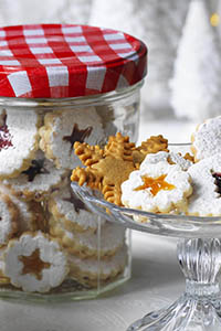 Linzer Cookies, Bonne Maman mini festive treats. Jam sandwich biscuits with a small shape cut out of the top biscuit showing the jam