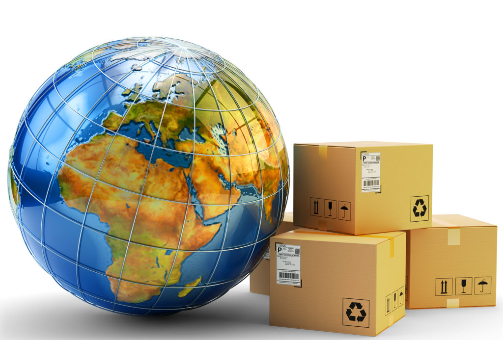 Model globe leaning against stack of 3 large parcels in cardboard boxes