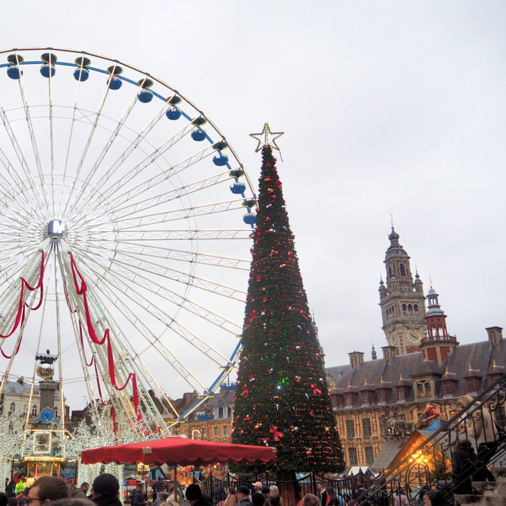 Ferris wheel and Christmas tree, stalls in foreground