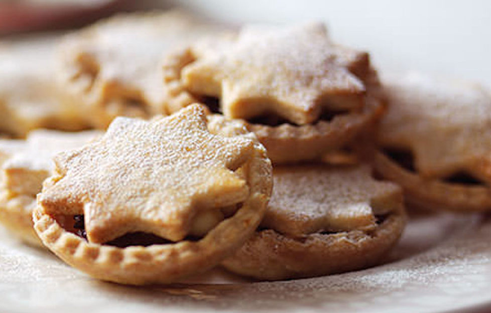 Mince pies with star shaped lids on a plate