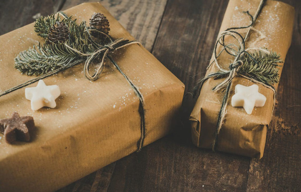 Sustainable gift wrapping idea, presents in brown paper with garden twine and natural pine sprigs