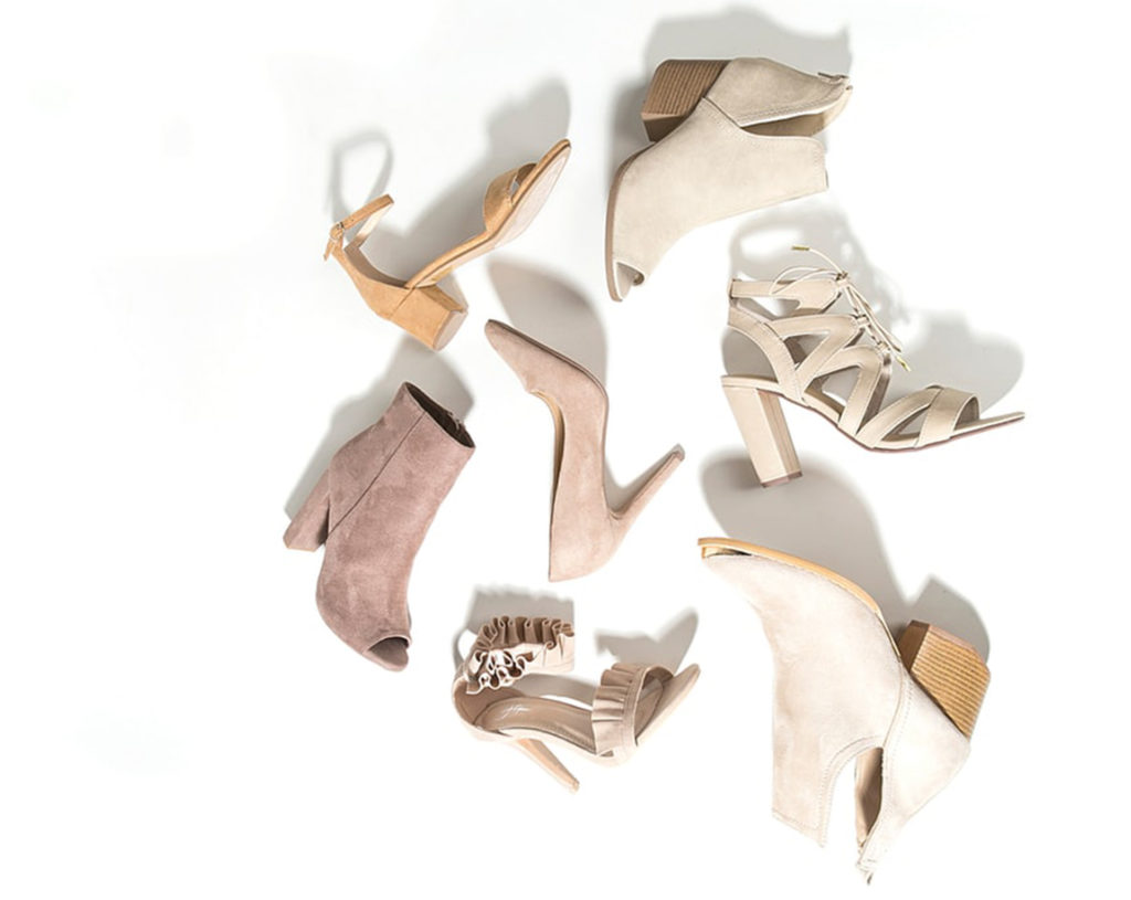 Assortment of cream and beige hoes and ankle boots lying on their sides