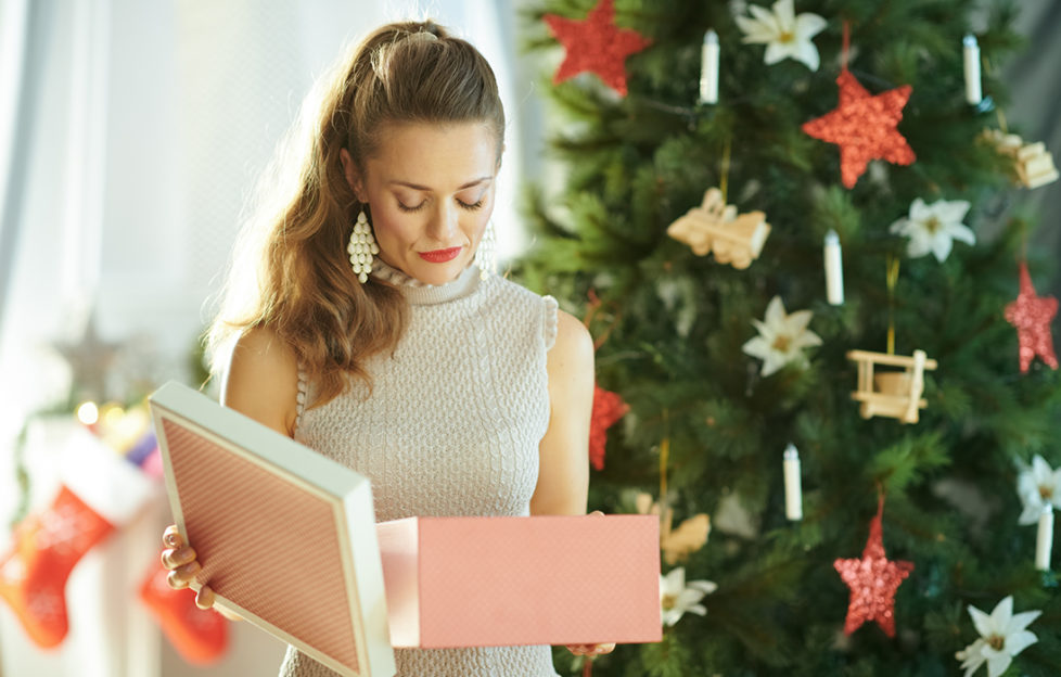 Woman opening present, looking disappointed
