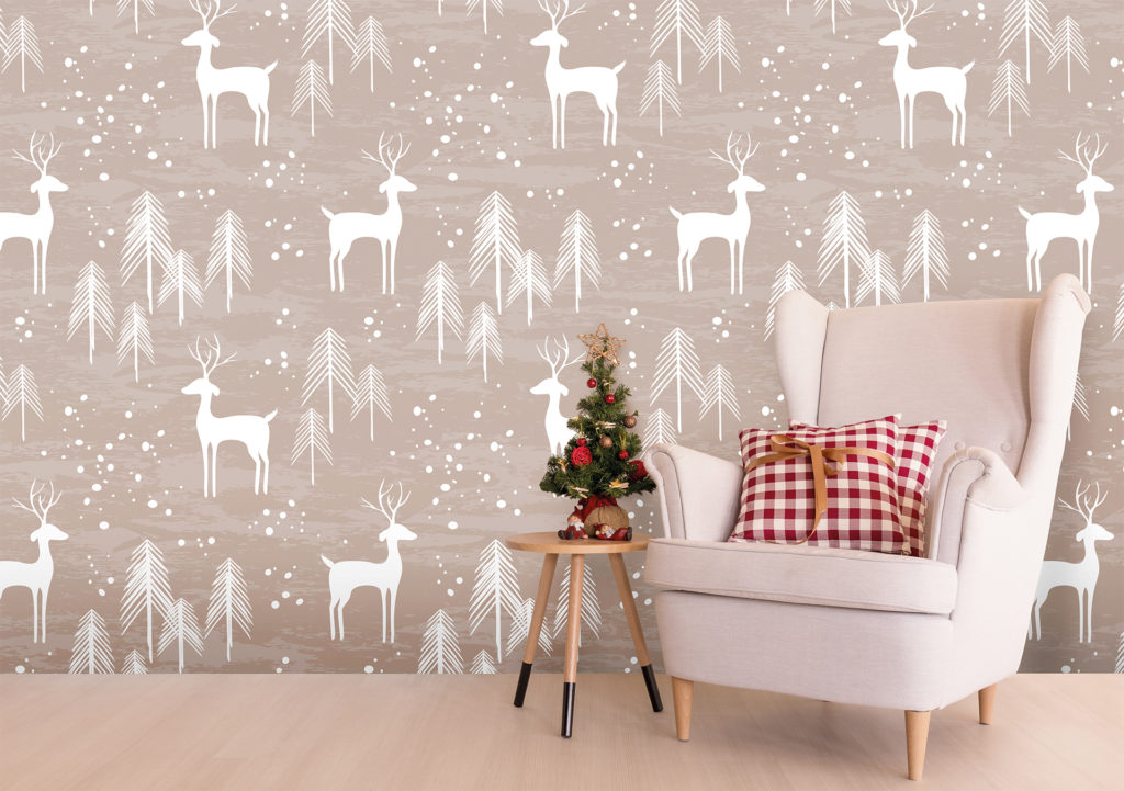 Wallpaper patterned with stylised white reindeer and trees on soft taupe backgroundLaminate floor, white armchair